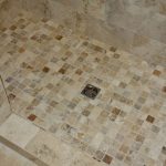 brown and white tile shower floor