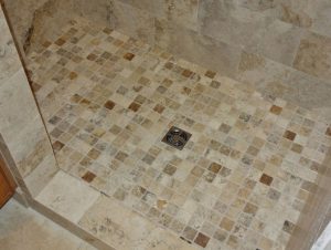 brown and white tile shower floor