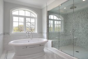 luxury white tub with glass shower beside it