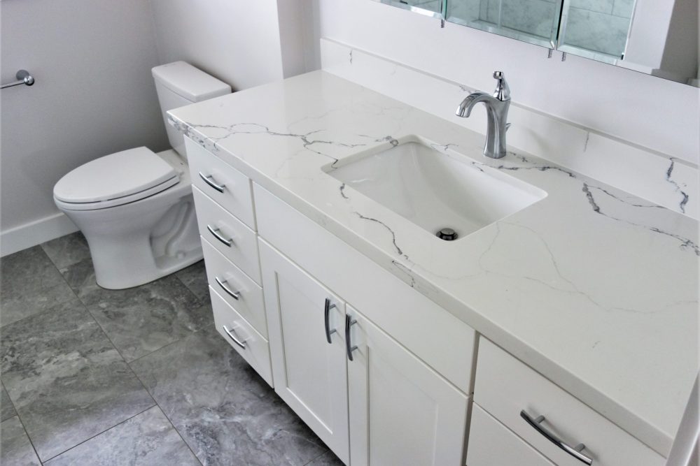 Guest Bathroom Remodel Quartz Counters with Shaker Doors and Slab Drawer Fronts